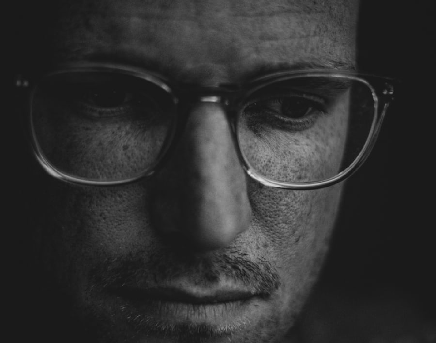 Close up of man wearing thick glasses